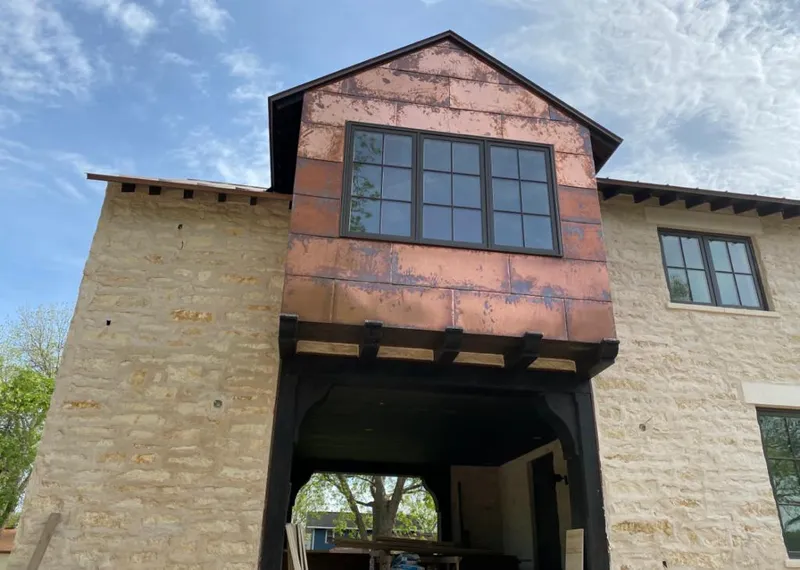 Copper metal panel facade on a stone building for Metal Roof Coating in Watertown